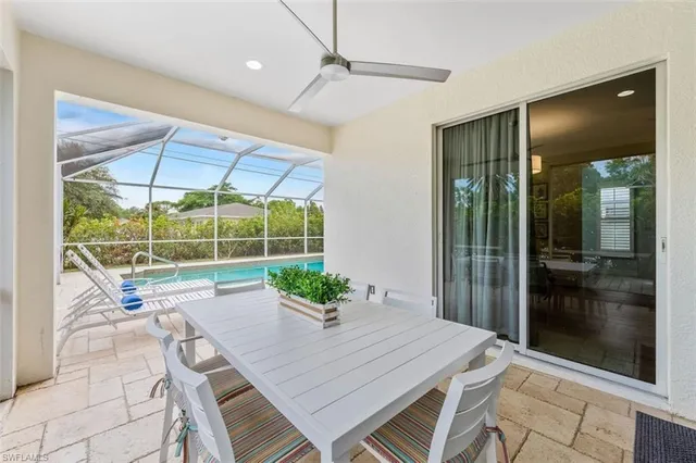 a dining room with a glass top table and chairs