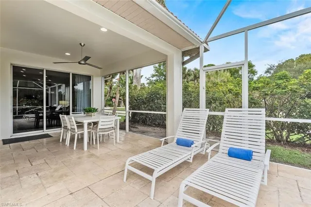 a view of a patio with a dining table and chairs