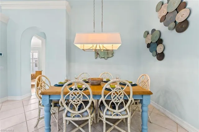 a view of a dining room with furniture and chandelier