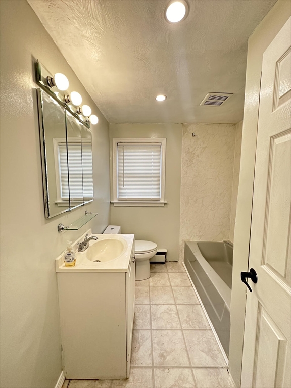 38 Hadley Street Springfield, MA 01118 - Photo 13 of 20 a bathroom with a sink a toilet and a mirror