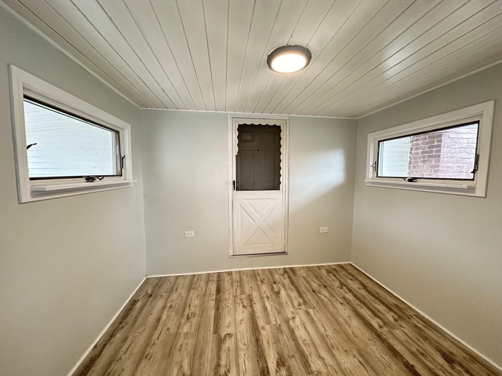 38 Hadley Street Springfield, MA 01118 - Photo 15 of 20 an empty room with wooden floor closet and windows