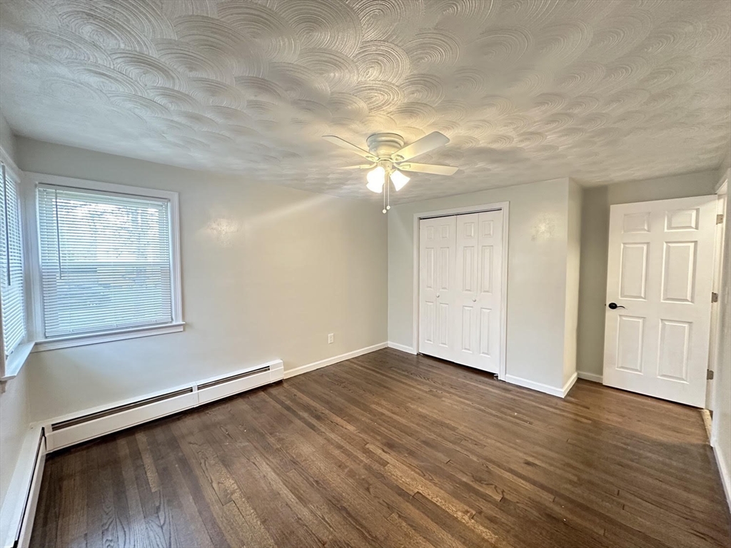 38 Hadley Street Springfield, MA 01118 - Photo 7 of 20 wooden floor in an empty room with a window