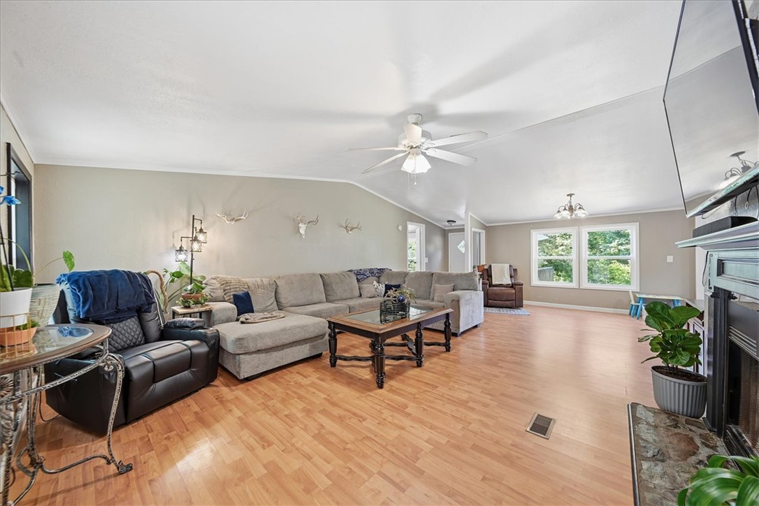 1014 Harris Road Anderson, SC 29625 - Photo 2 of 34 An inviting gathering space, this living room features vaulted ceilings, ample natural light, and a cozy fireplace.