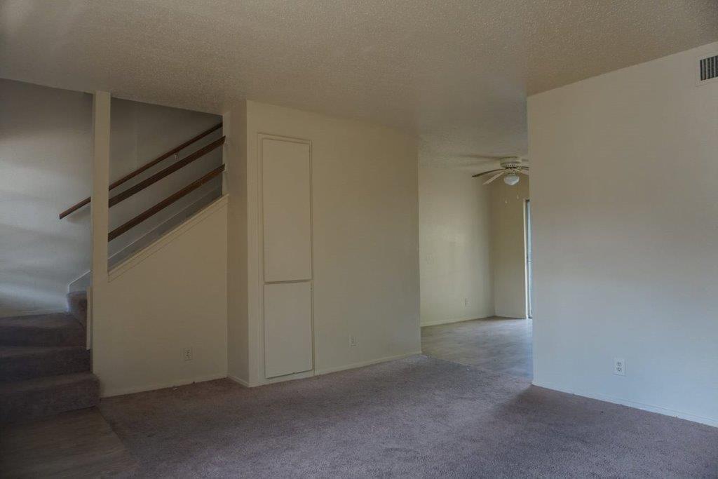 5919 Hidden Valley Trail Austin, TX 78744 - Photo 2 of 8 A split-level interior offers a practical layout with carpeted stairs leading to the upper floor.