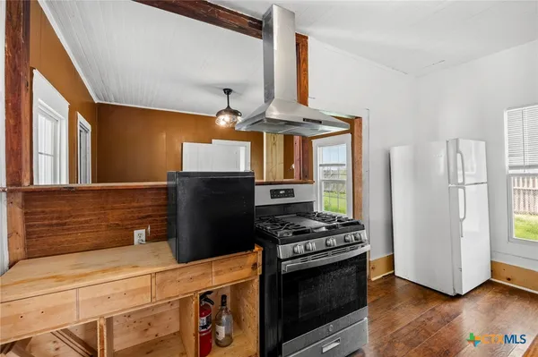 a kitchen with stainless steel appliances a stove and a refrigerator