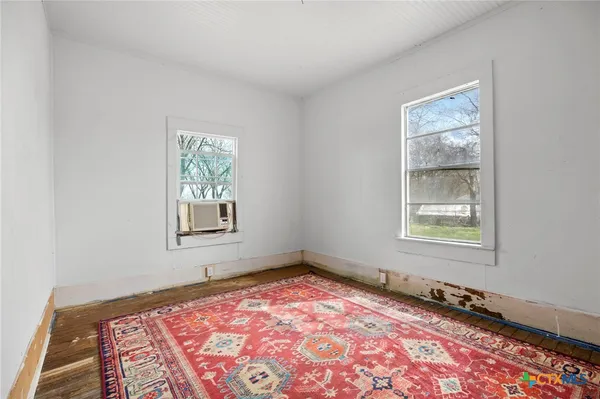 a large bed sitting in a bedroom next to a window