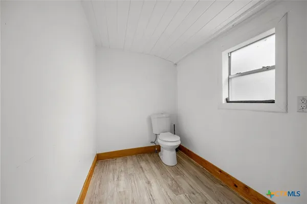 a bathroom with a toilet and a vanity