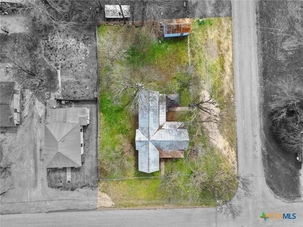 a aerial view of a house with outdoor space pool seating area and yard
