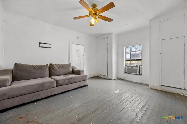a living room with furniture and a window