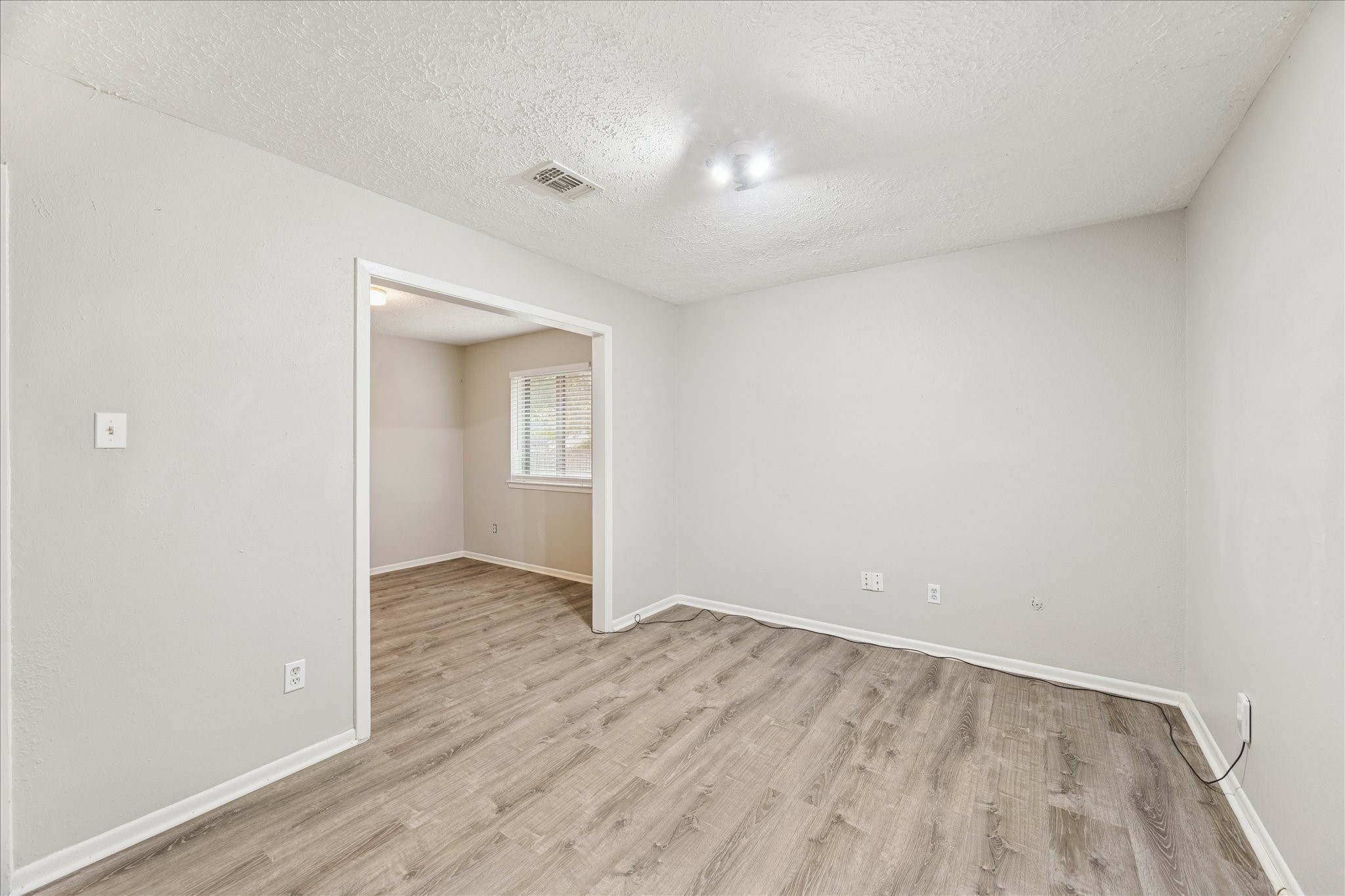 3503 Willie Way Spring, TX 77380 - Photo 13 of 20 an empty room with wooden floor and windows
