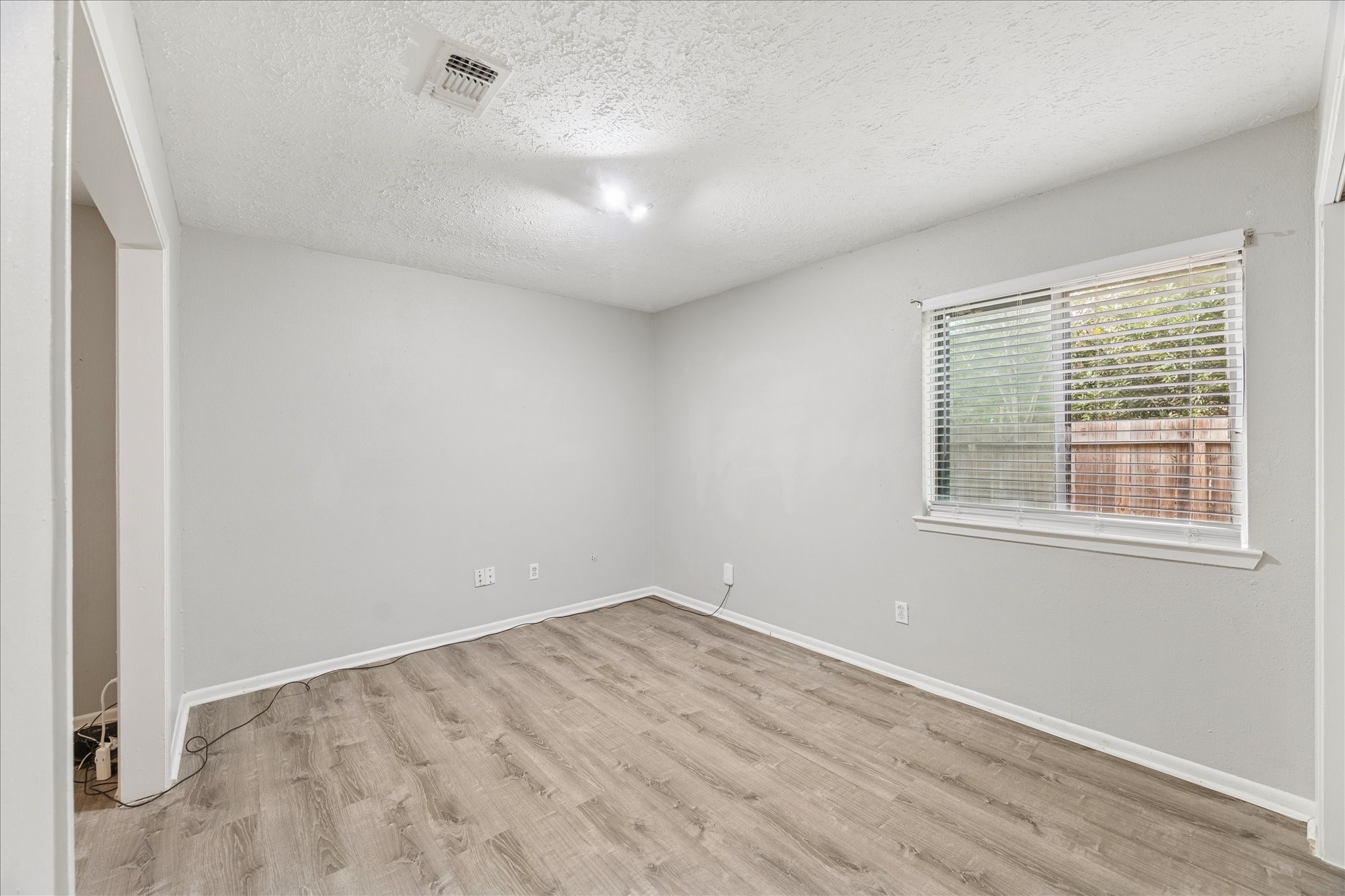 3503 Willie Way Spring, TX 77380 - Photo 14 of 20 an empty room with wooden floor and windows