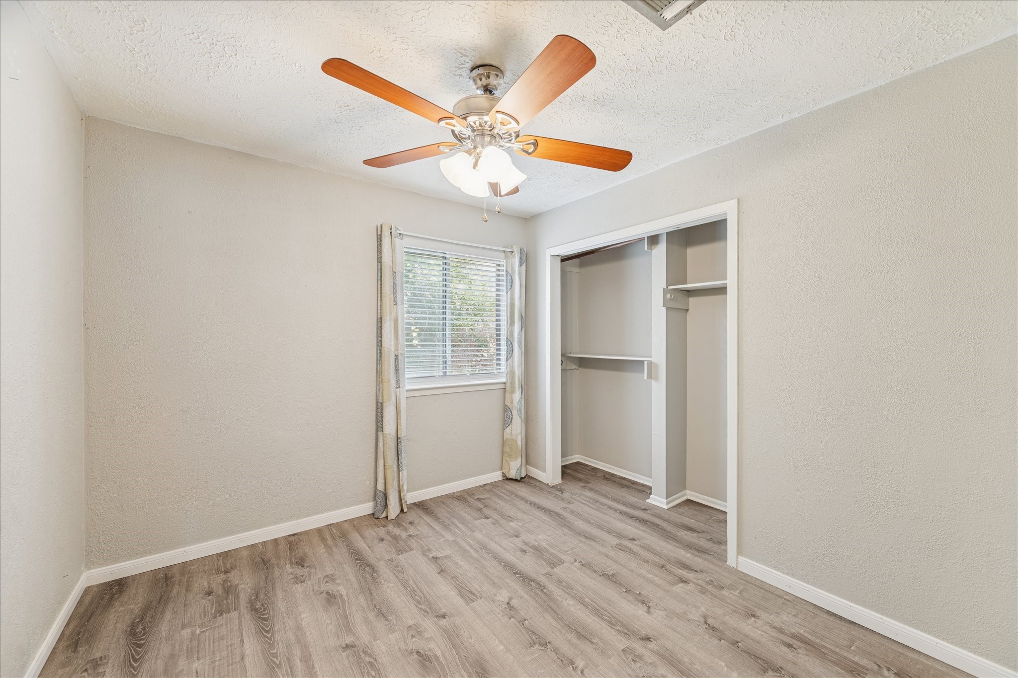 3503 Willie Way Spring, TX 77380 - Photo 15 of 20 an empty room with wooden floor fan and windows