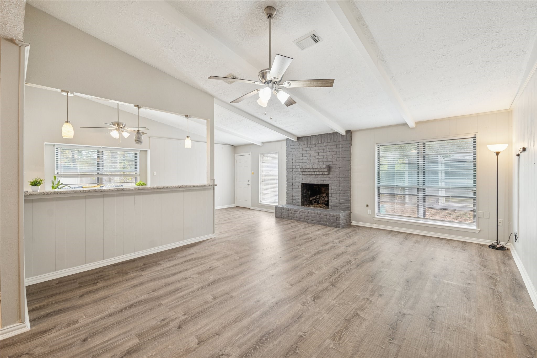 3503 Willie Way Spring, TX 77380 - Photo 3 of 20 a view of an empty room with a kitchen and wooden floor