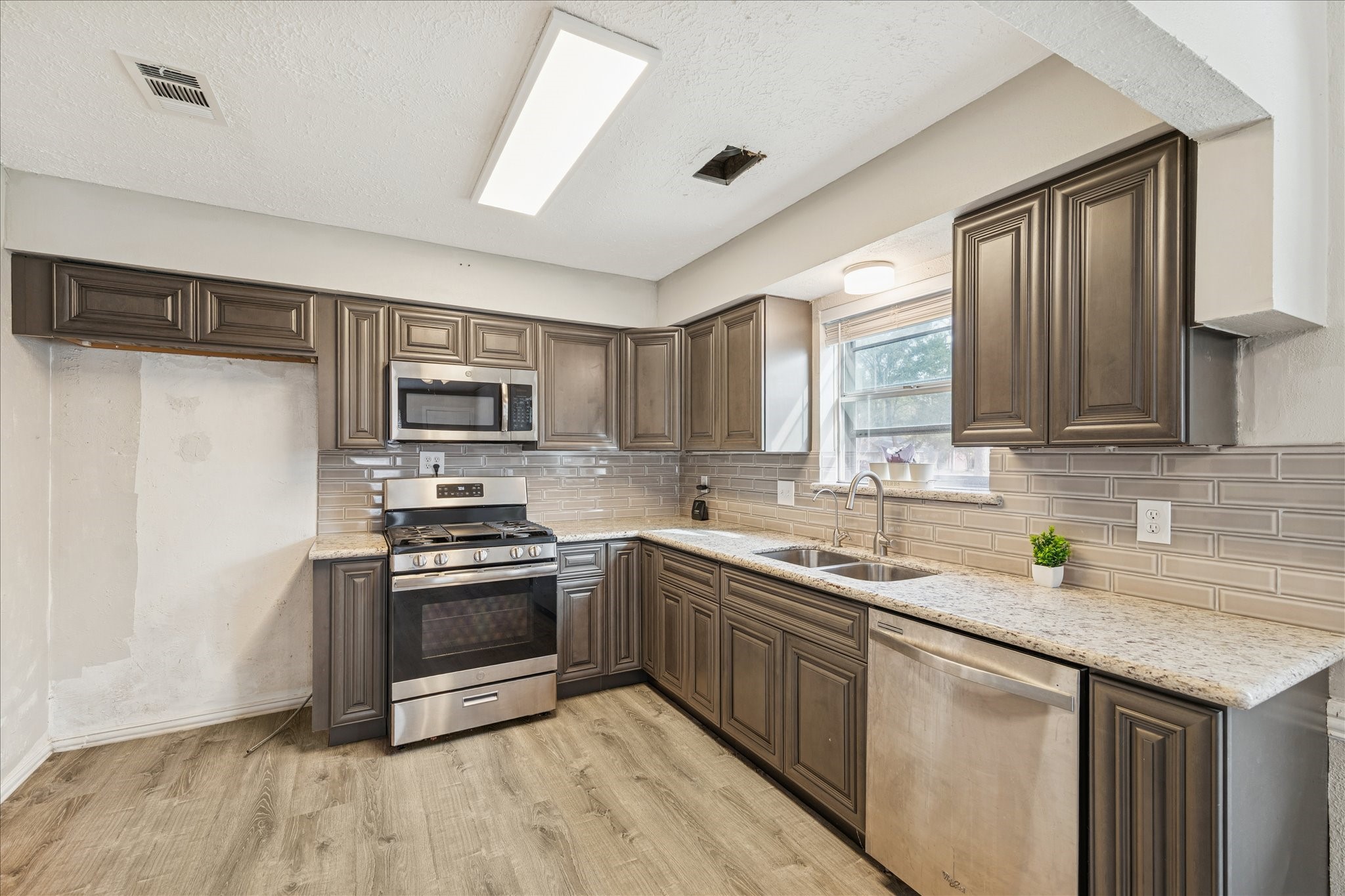 3503 Willie Way Spring, TX 77380 - Photo 7 of 20 a kitchen with stainless steel appliances granite countertop a sink stove microwave and refrigerator