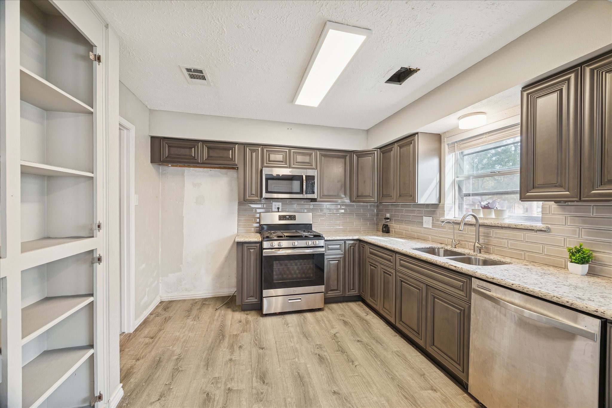 3503 Willie Way Spring, TX 77380 - Photo 8 of 20 a kitchen with stainless steel appliances granite countertop a sink stove and refrigerator