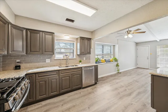 a large kitchen with a sink and cabinets