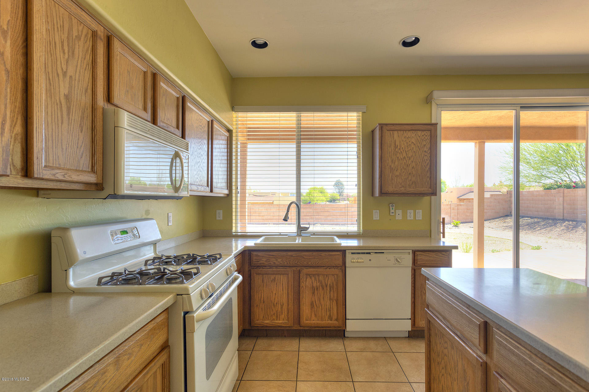 369 Via Capri Rio Rico, AZ 85648 - Photo 11 of 31 a kitchen with a sink stove top oven and cabinets