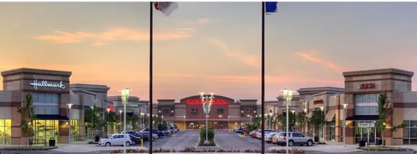 a view of a yard with wooden fence