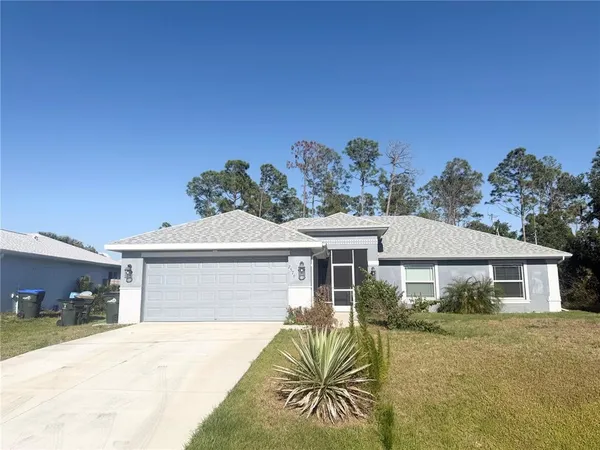 a front view of a house with a yard and outdoor seating