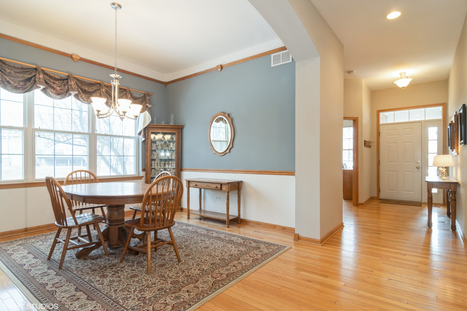 312 Quarry Ridge Circle Sugar Grove, IL 60554 - Photo 3 of 23 a view of a dining room with furniture and wooden floor