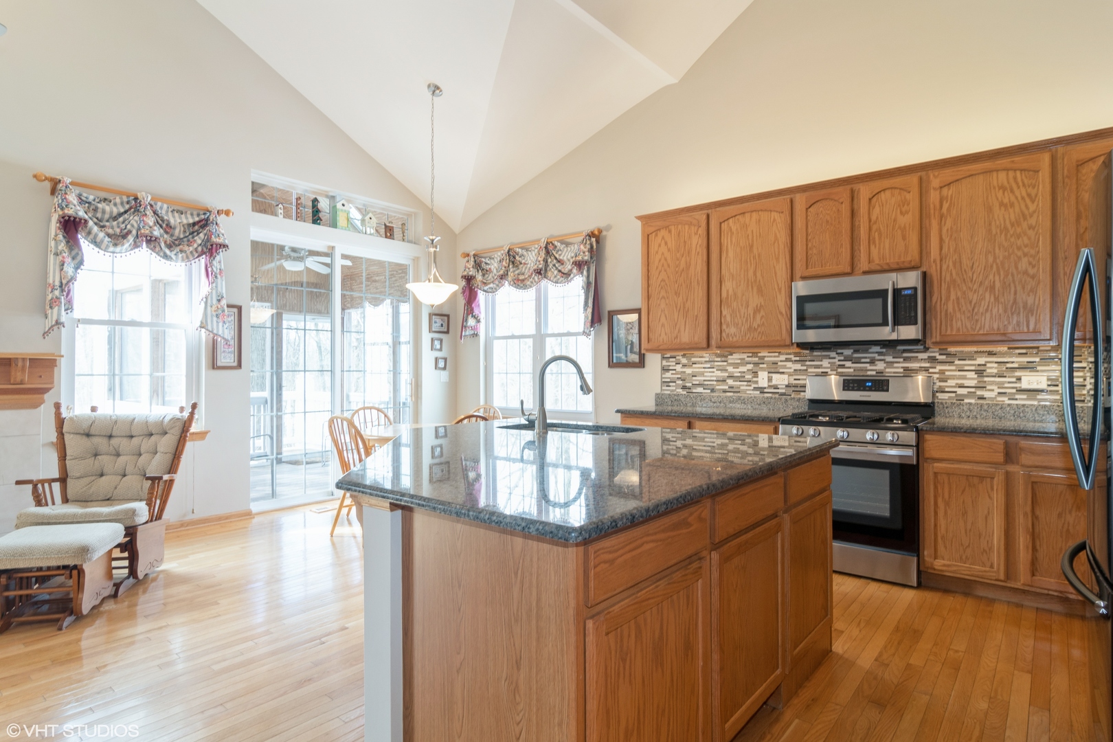 312 Quarry Ridge Circle Sugar Grove, IL 60554 - Photo 5 of 23 a kitchen with stainless steel appliances granite countertop a stove top oven a sink dishwasher a dining table and chairs with wooden floor