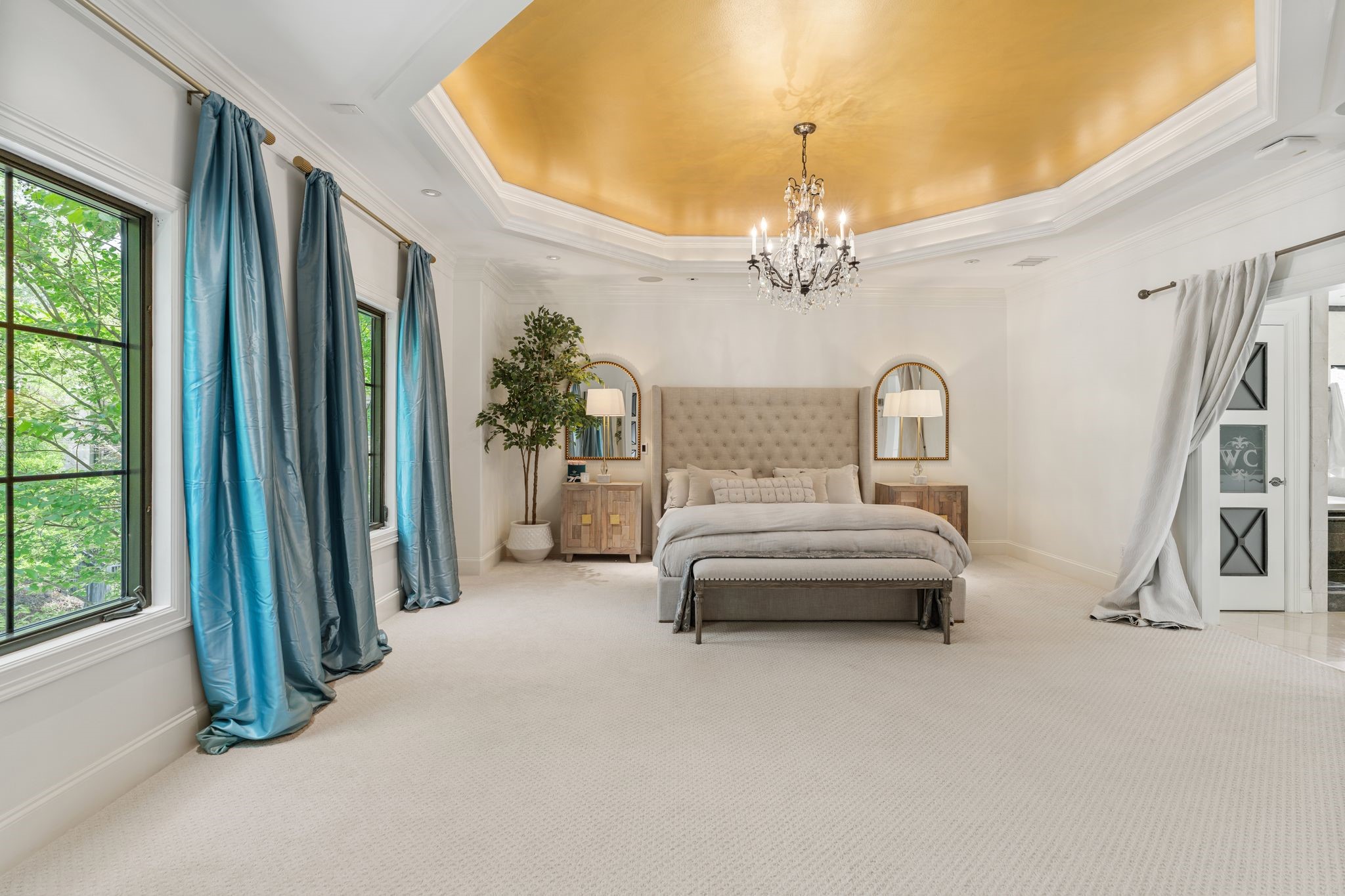30 Hackberry Lane, Unit A Houston, TX 77027 - Photo 23 of 42 The primary suite features a coved ceiling with coved lighting with a glass chandelier taking center stage.