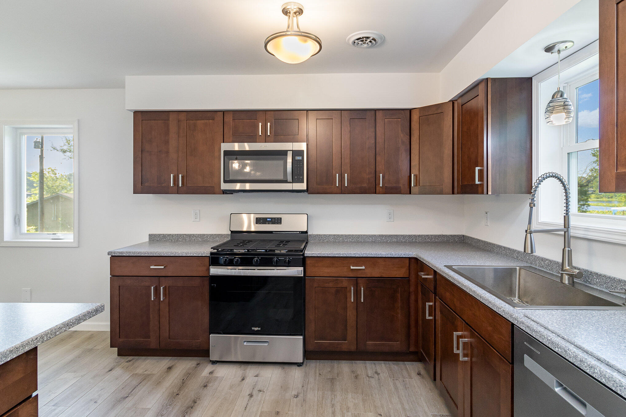 44 Vick Tree Lane Hebron, IN 46341 - Photo 12 of 29 a kitchen with sink a microwave and cabinets