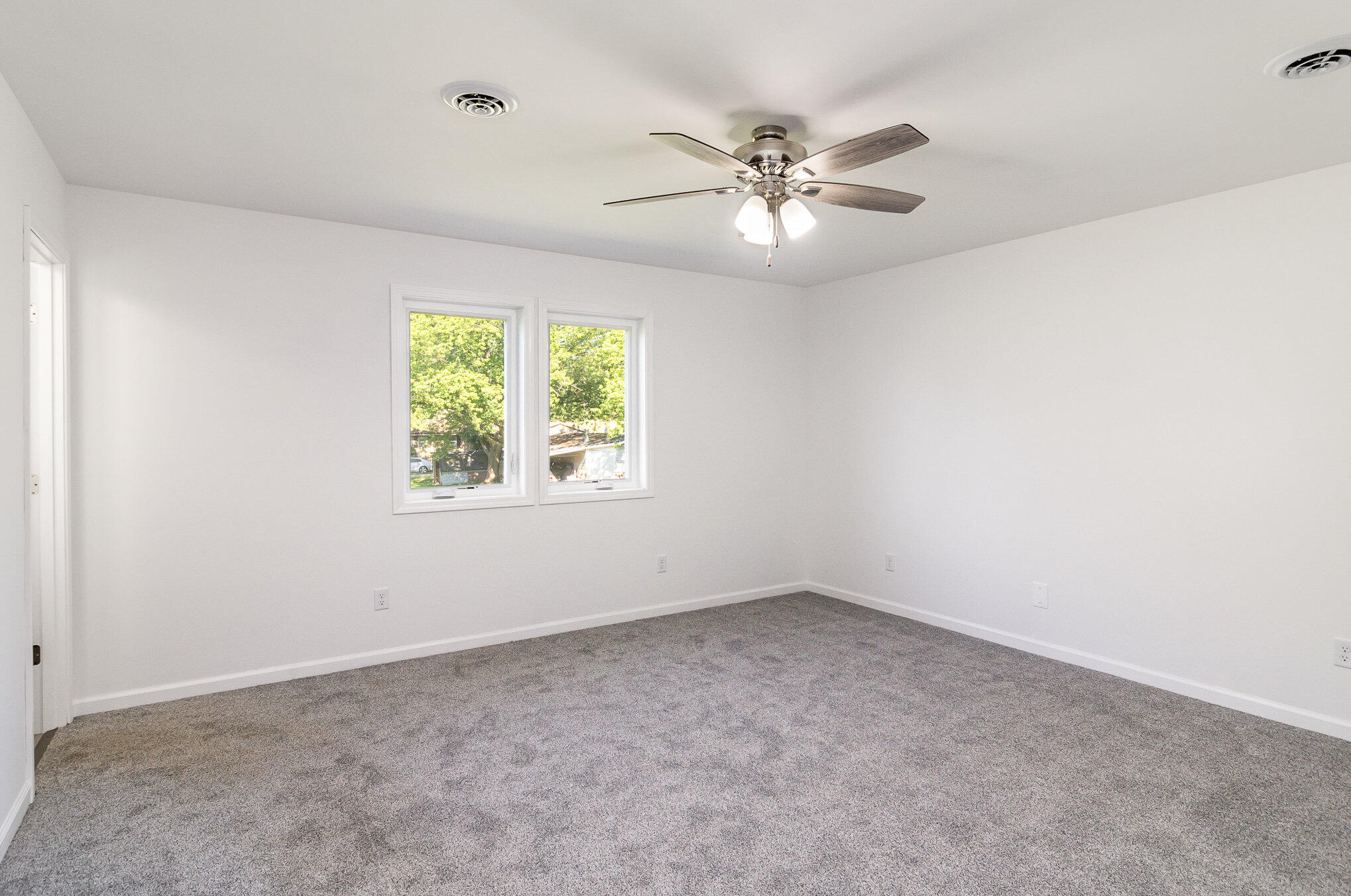 44 Vick Tree Lane Hebron, IN 46341 - Photo 14 of 29 an empty room with windows and fan