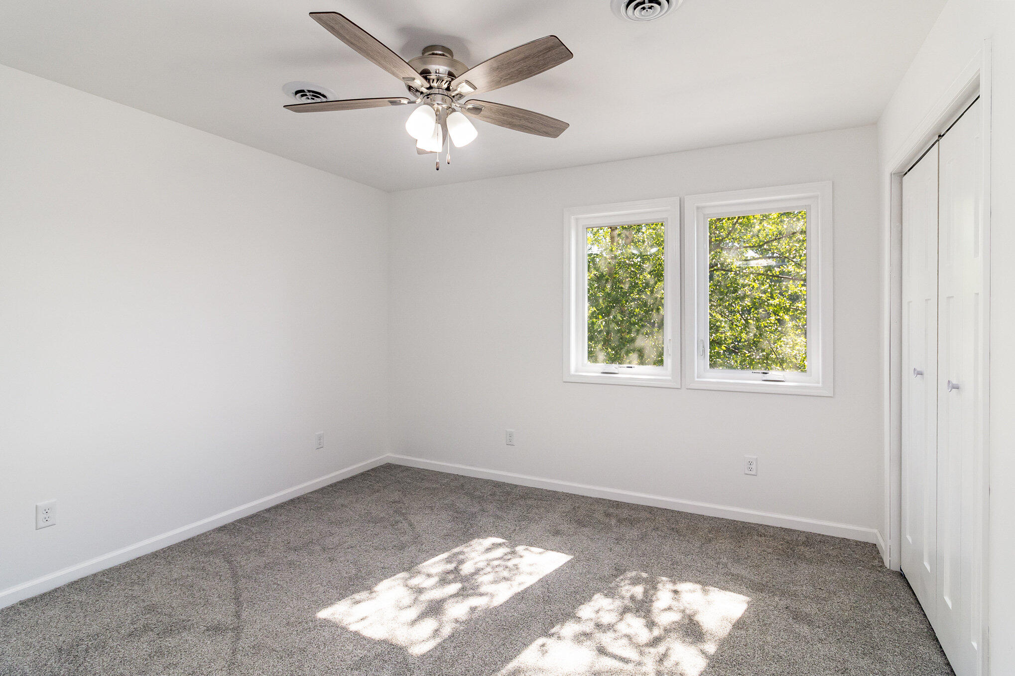 44 Vick Tree Lane Hebron, IN 46341 - Photo 17 of 29 a view of a big room with windows and chandelier fan
