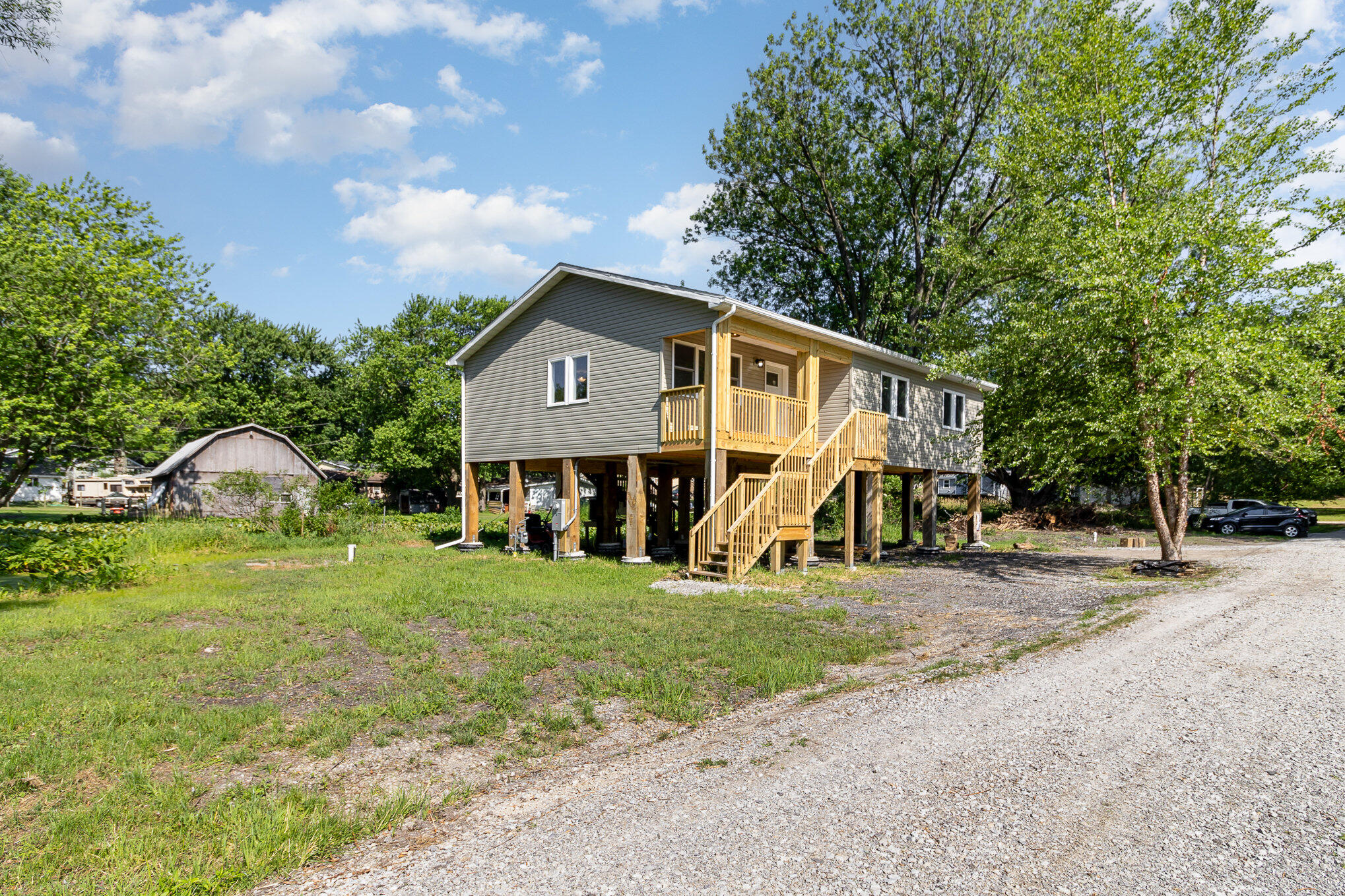 44 Vick Tree Lane Hebron, IN 46341 - Photo 2 of 29 a front view of a house with garden