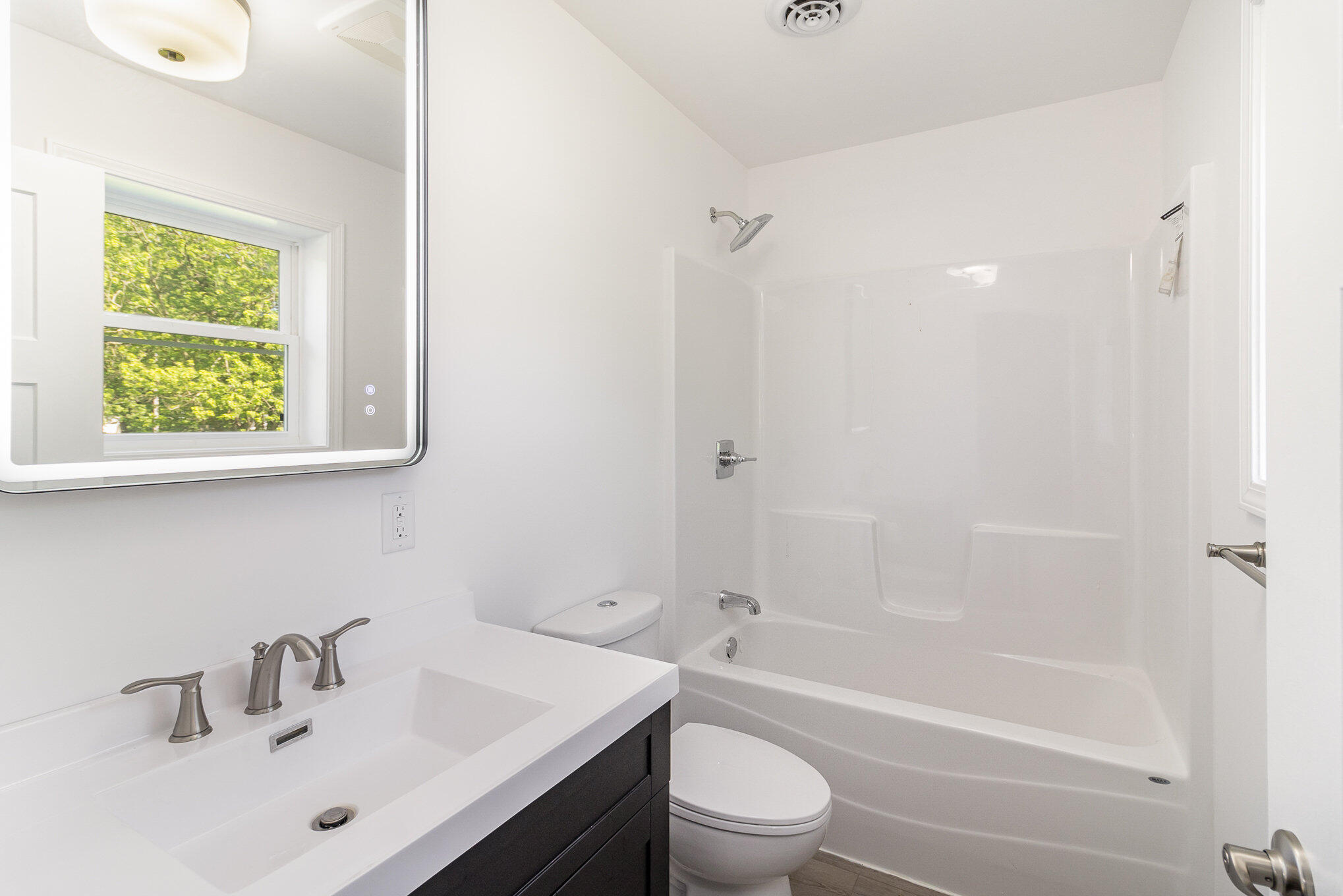 44 Vick Tree Lane Hebron, IN 46341 - Photo 21 of 29 a bathroom with a bathtub shower sink vanity mirror and toilet