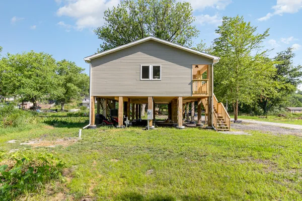 a view of a house with a yard and sitting area
