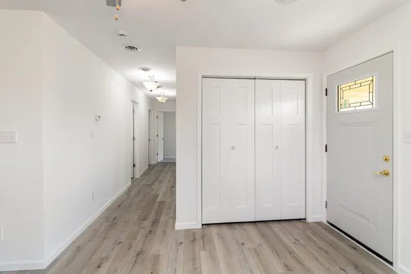 a view of a hallway with wooden floor