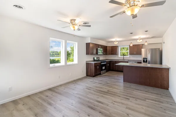 a large kitchen with a center island and stainless steel appliances
