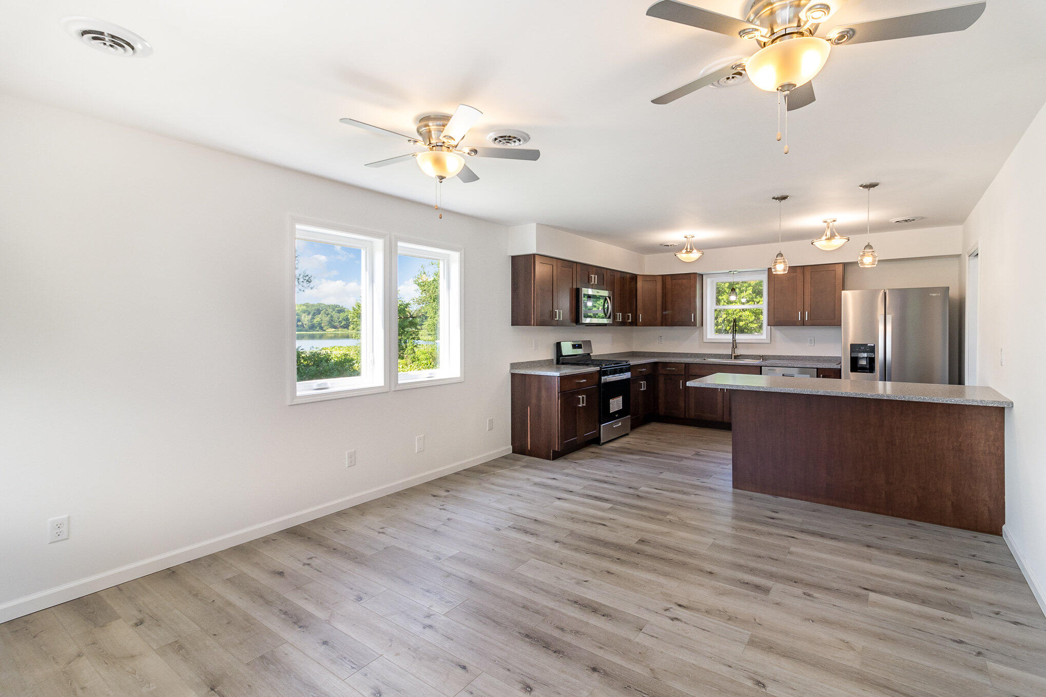 44 Vick Tree Lane Hebron, IN 46341 - Photo 9 of 29 a large kitchen with a center island and stainless steel appliances