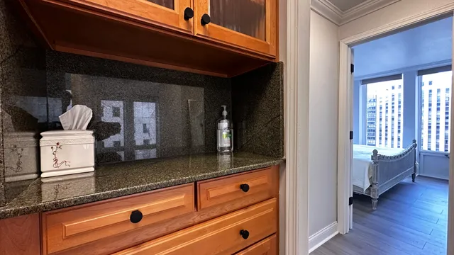 a view of a hallway with entryway and wooden floor