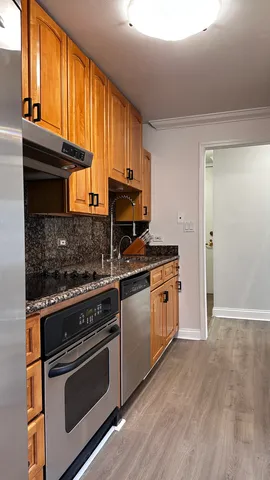 a kitchen with stainless steel appliances granite countertop a stove a sink and a microwave