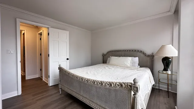 a view of a room with a large window and a bed