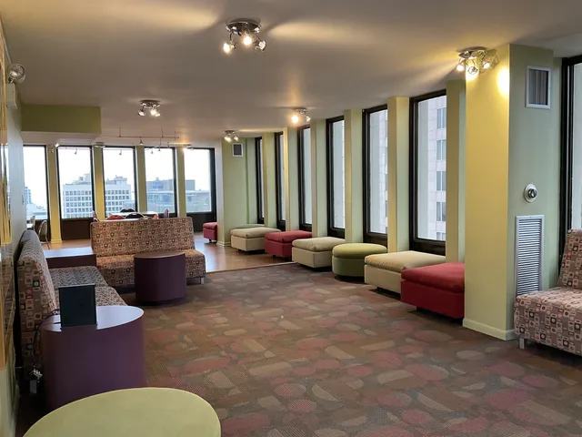 a open kitchen with stainless steel appliances kitchen island granite countertop a stove a sink dishwasher and white cabinets with wooden floor