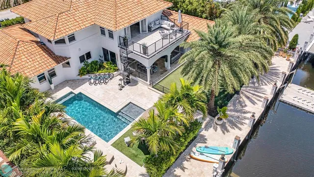 an aerial view of a house with a yard and potted plants