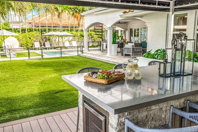 a living room with furniture and a refrigerator