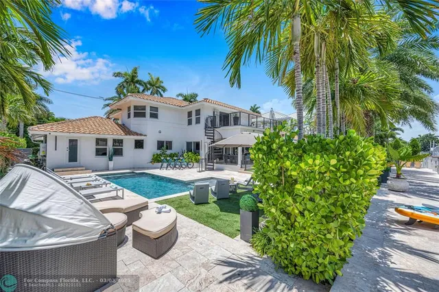 a living room with furniture and a refrigerator