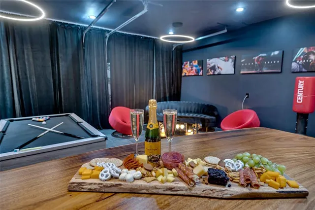a bedroom with a large bed and wooden floor