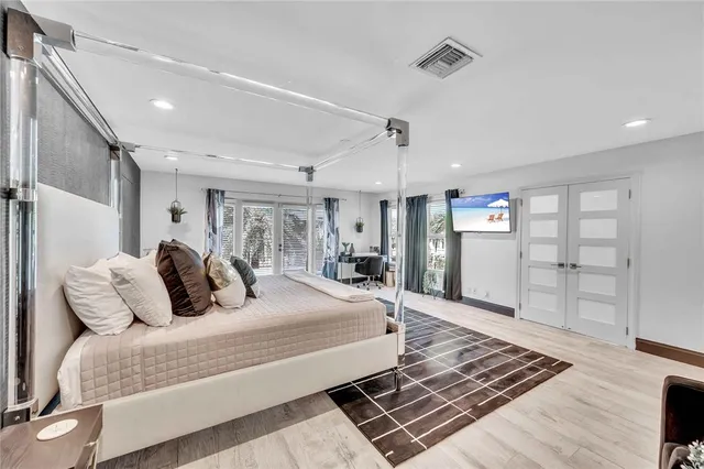 a bedroom with a bed and cabinets