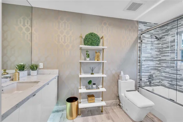 a spacious bedroom with a bed and glass windows