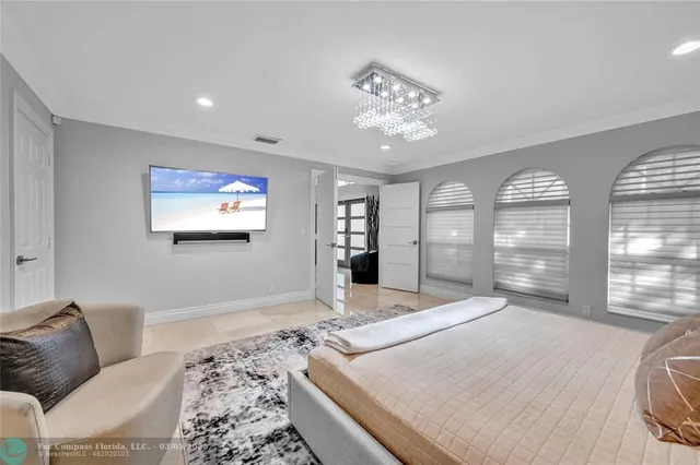 a bedroom with a bed and large window