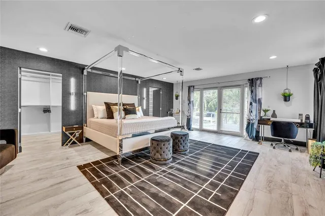 a bedroom with furniture and wooden floor