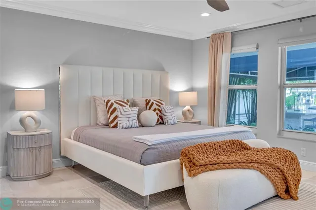 a spacious bedroom with a bed and a large window