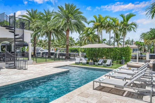 a view of yard with swimming pool and trees