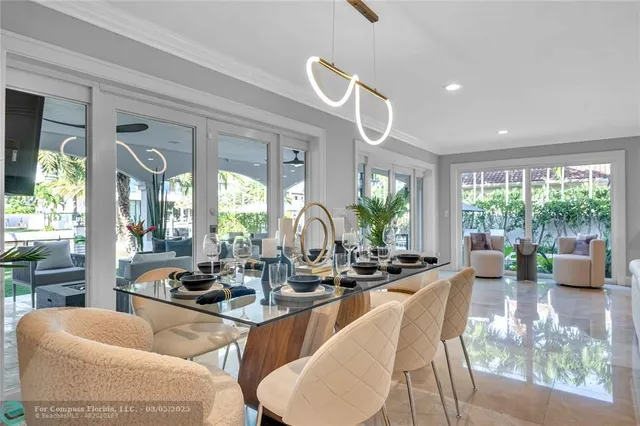 a room with furniture large windows and wooden floor